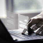 A close-up of a person's hands using a laptop keyboard with a digital overlay of document icons, representing a Data Protection Officer utilizing compliance automation software to manage digital records and DPDP Act requirements